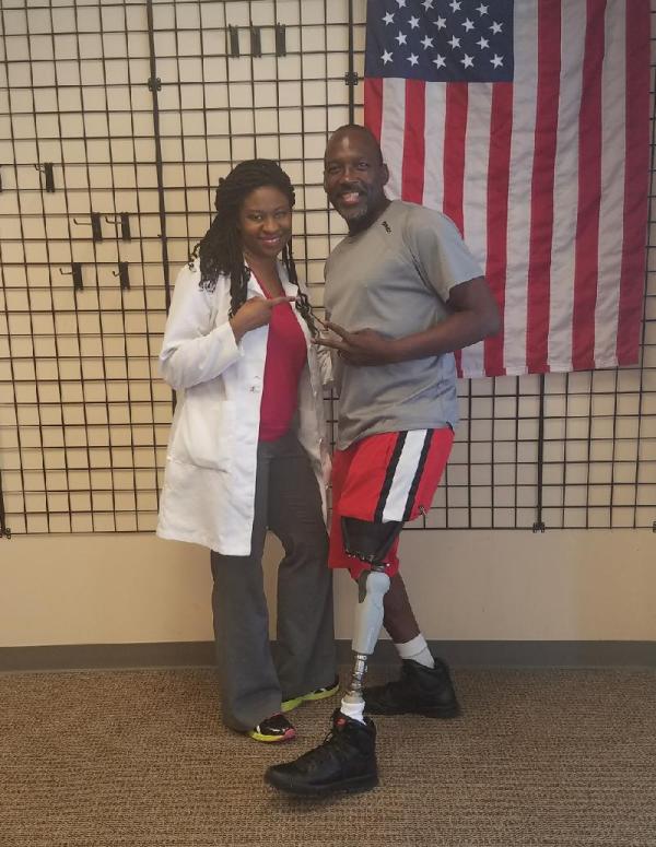 man standing with medical professional showing off his new prosthetic leg